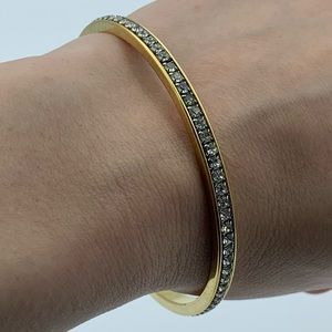 A rhinestone gold bangle